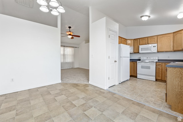 kitchen featuring white appliances, ceiling fan with notable chandelier, and lofted ceiling