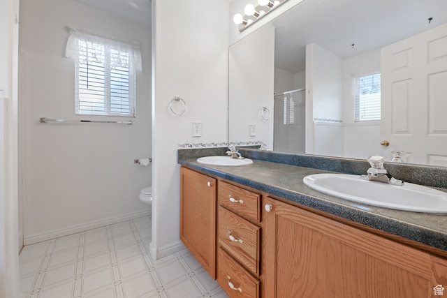 bathroom featuring toilet, an enclosed shower, and vanity