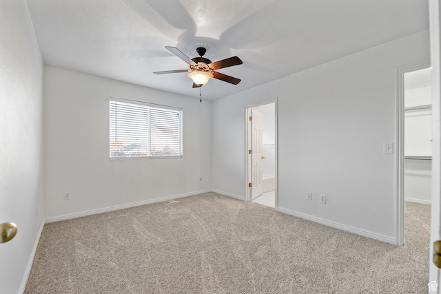 empty room featuring light carpet and ceiling fan