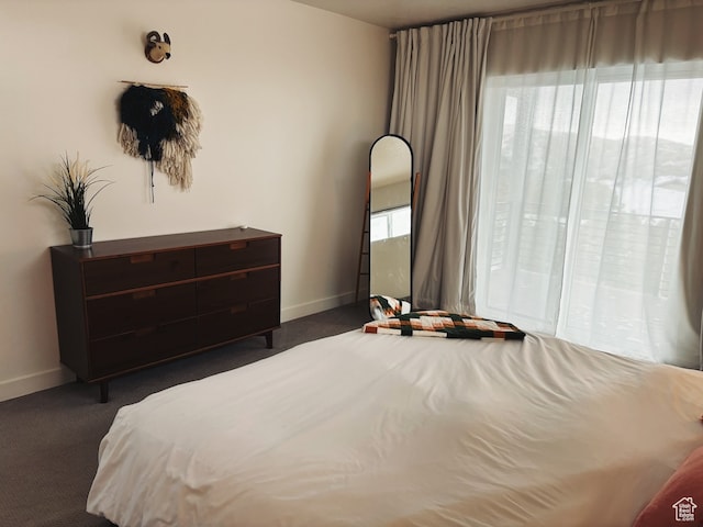 carpeted bedroom featuring multiple windows
