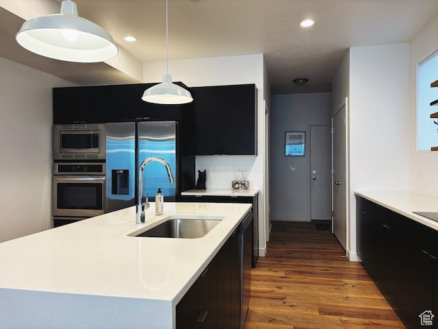 15224 S Tall Woods Dr, Draper Ut Cnty, UT 84020 - kitchen featuring dark cabinets, appliances with stainless steel finishes, a sink, wood finished floors, and recessed lighting