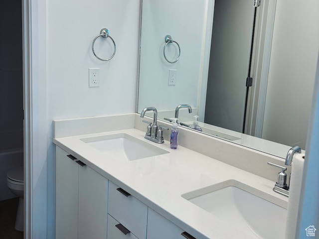bathroom featuring toilet and vanity