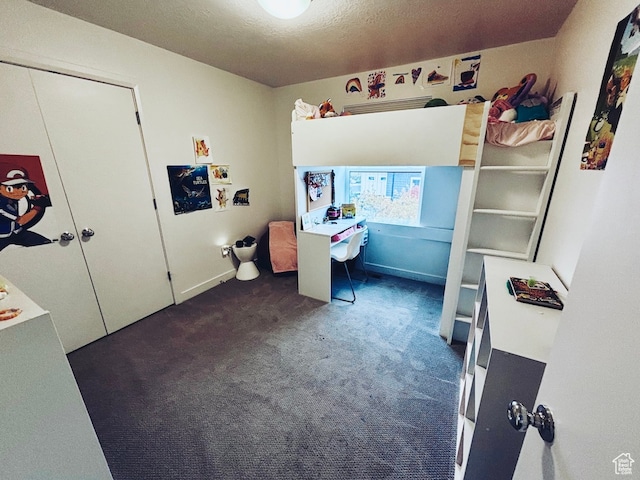 carpeted bedroom featuring a closet and a textured ceiling