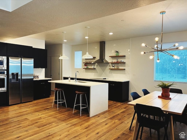 15224 S Tall Woods Dr, Draper Ut Cnty, UT 84020 - kitchen featuring stainless steel appliances, dark cabinetry, open shelves, wall chimney exhaust hood, and a textured ceiling