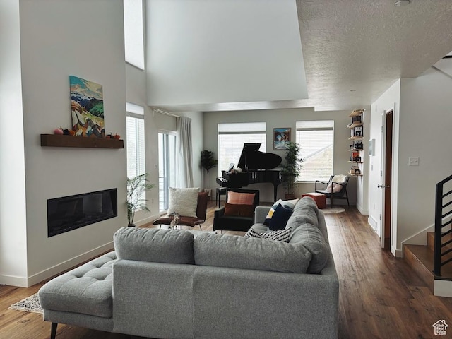 15224 S Tall Woods Dr, Draper Ut Cnty, UT 84020 - living room with a glass covered fireplace, baseboards, wood finished floors, a textured ceiling, and stairs