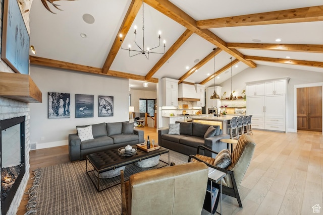 3300 E Hunters Ridge Cir, Heber City, UT 84032 - living area with a chandelier, light wood-style floors, a fireplace, baseboards, and recessed lighting
