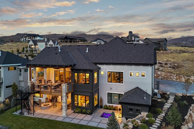 3300 E Hunters Ridge Cir, Heber City, UT 84032 - rear view of property with an outdoor fire pit, a patio, roof with shingles, and a mountain view