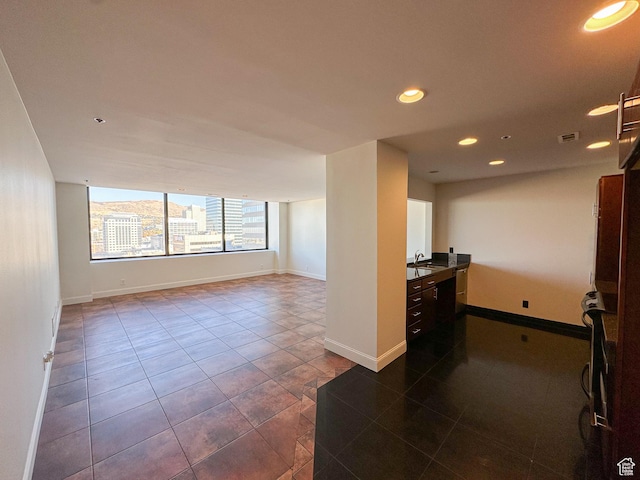 48 W Broadway Unit 2505N, Salt Lake City, UT 84101 - empty room with a sink, recessed lighting, dark tile patterned flooring, and baseboards