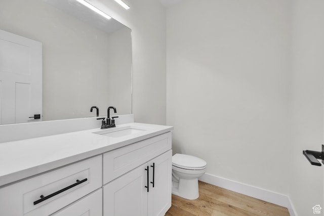 7901 S 2700 E Unit 203, South Weber, UT 84405 - bathroom featuring toilet, vanity, wood finished floors, and baseboards