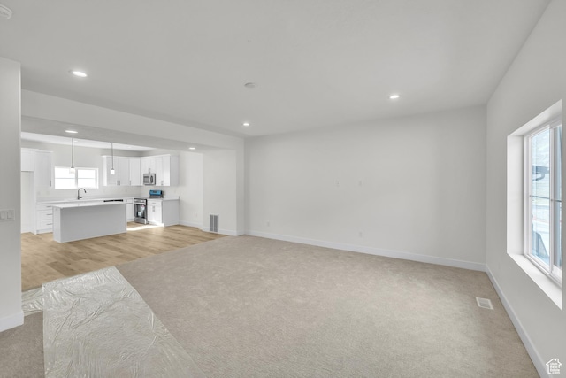 7901 S 2700 E Unit 203, South Weber, UT 84405 - unfurnished living room with recessed lighting, light colored carpet, and a sink