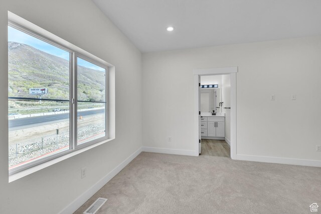 7901 S 2700 E Unit 203, South Weber, UT 84405 - unfurnished bedroom featuring recessed lighting, visible vents, light carpet, connected bathroom, and baseboards