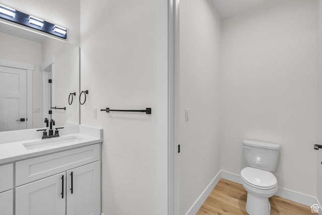 7901 S 2700 E Unit 203, South Weber, UT 84405 - bathroom featuring wood finished floors, baseboards, vanity, and toilet