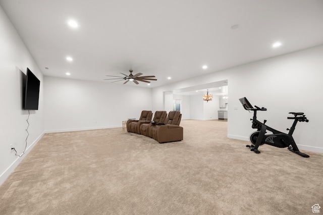 exercise room with ceiling fan with notable chandelier and light carpet