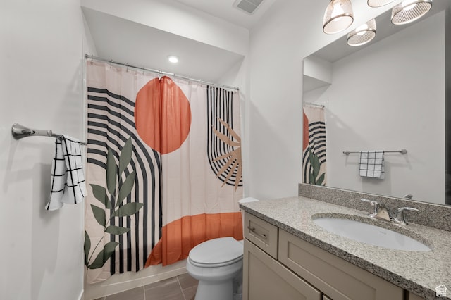 bathroom with toilet, vanity, tile patterned flooring, and walk in shower