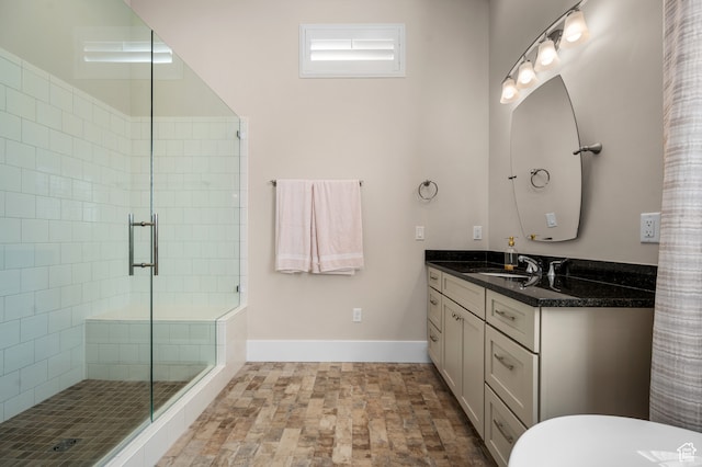 bathroom with walk in shower and vanity