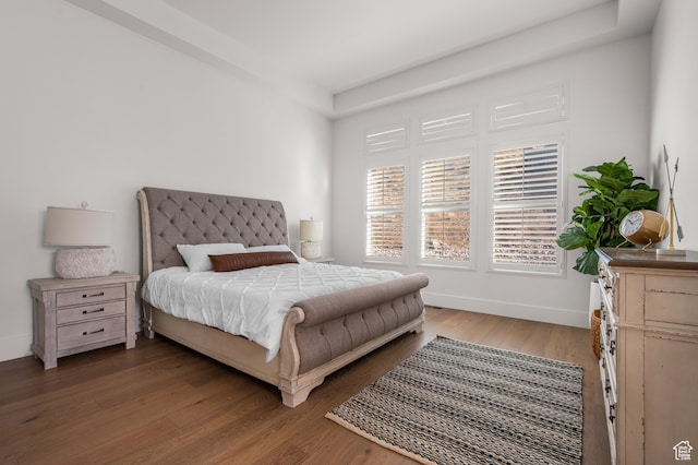 bedroom with dark hardwood / wood-style flooring