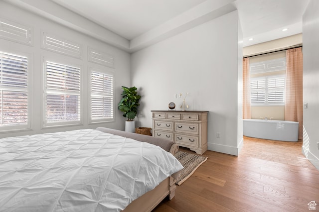 bedroom featuring light wood-type flooring and multiple windows