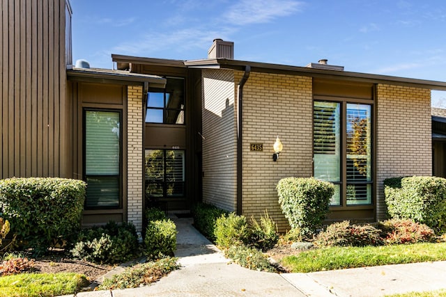 6435 S 1610 E, Murray, UT 84121 - doorway to property with brick siding and a chimney