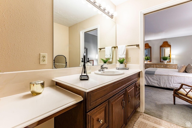 6435 S 1610 E, Murray, UT 84121 - bathroom with vanity, a textured wall, and connected bathroom