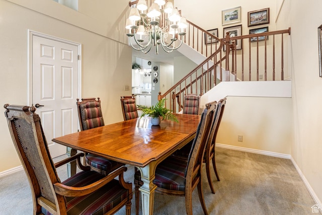 6435 S 1610 E, Murray, UT 84121 - carpeted dining area with a chandelier, stairway, baseboards, and a towering ceiling
