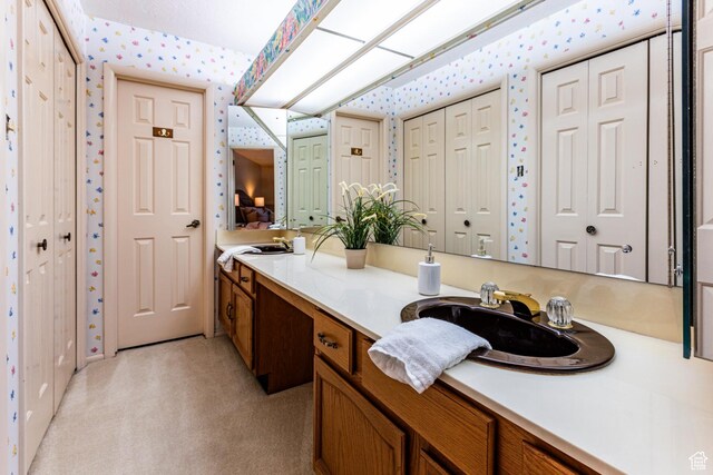 6435 S 1610 E, Murray, UT 84121 - ensuite bathroom featuring wallpapered walls, a closet, and vanity