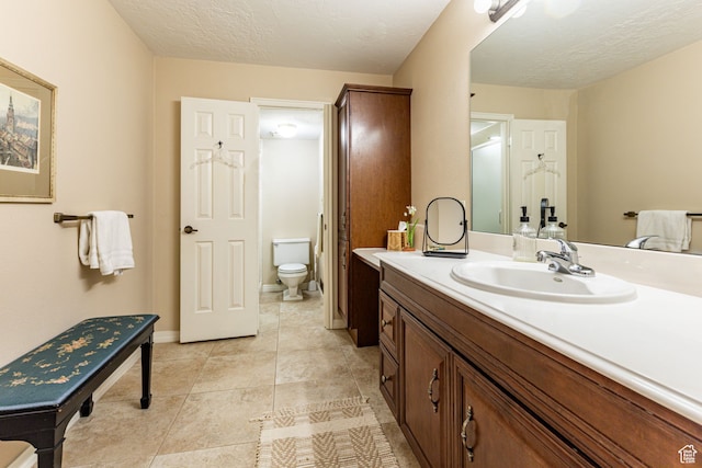6435 S 1610 E, Murray, UT 84121 - bathroom with toilet, vanity, tile patterned flooring, a textured ceiling, and baseboards