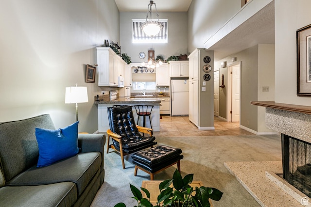 6435 S 1610 E, Murray, UT 84121 - living room with a high ceiling, light colored carpet, baseboards, and a multi sided fireplace