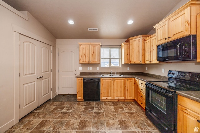 kitchen featuring light brown cabinetry, sink, and black appliances