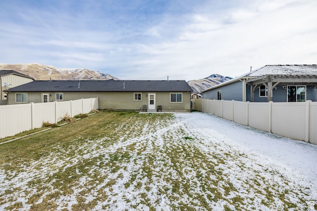 snow covered house featuring a mountain view