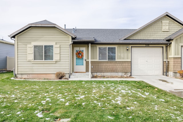 ranch-style home with a garage and a front lawn