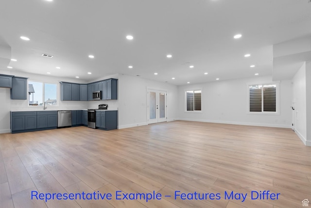 3689 S Riverstone Rd, Mapleton, UT 84664 - unfurnished living room featuring light wood-style floors, recessed lighting, baseboards, a sink, and french doors