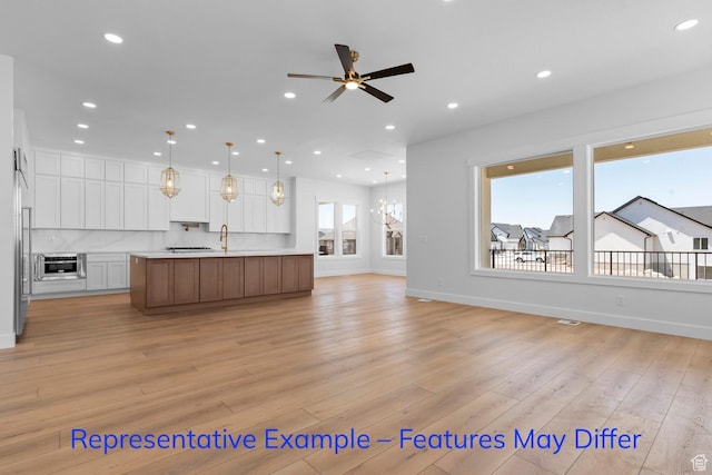 3689 S Riverstone Rd, Mapleton, UT 84664 - unfurnished living room featuring recessed lighting, ceiling fan, light wood-style flooring, baseboards, and a chandelier