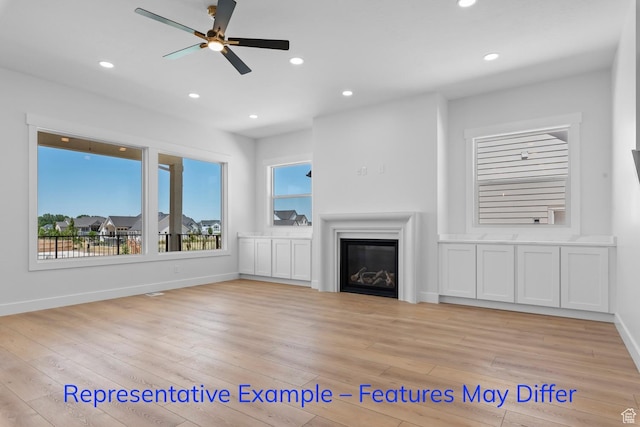 3689 S Riverstone Rd, Mapleton, UT 84664 - unfurnished living room with plenty of natural light, light wood-type flooring, baseboards, and recessed lighting