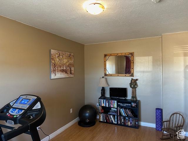 3741 W 5200 N, Cedar City, UT 84721 - workout room featuring wood finished floors, a textured ceiling, and baseboards