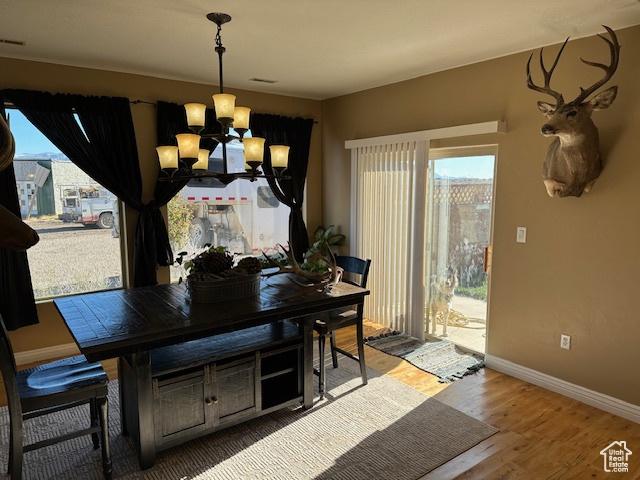 3741 W 5200 N, Cedar City, UT 84721 - dining space featuring a chandelier, baseboards, healthy amount of natural light, and wood finished floors