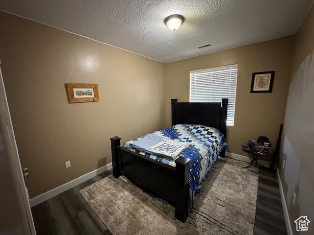 3741 W 5200 N, Cedar City, UT 84721 - bedroom featuring a textured ceiling, wood finished floors, and baseboards
