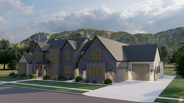 view of front of house featuring a garage, a front yard, and a mountain view
