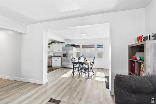 2034 S Laine Ave E, Ogden, UT 84401 - kitchen featuring appliances with stainless steel finishes, open floor plan, white cabinetry, and light wood-type flooring