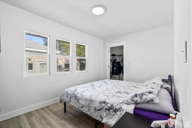 2034 S Laine Ave E, Ogden, UT 84401 - bedroom with wood finished floors, baseboards, and a spacious closet