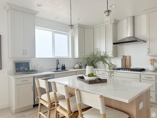 577 N Hawthorn Dr Unit 29, Salem, UT 84653 - kitchen with wall chimney exhaust hood, a sink, appliances with stainless steel finishes, light wood-style flooring, and a breakfast bar area