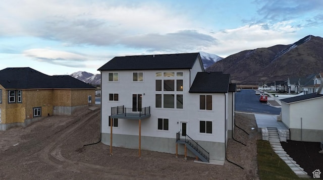 577 N Hawthorn Dr Unit 29, Salem, UT 84653 - rear view of property with a balcony, a mountain view, and stucco siding