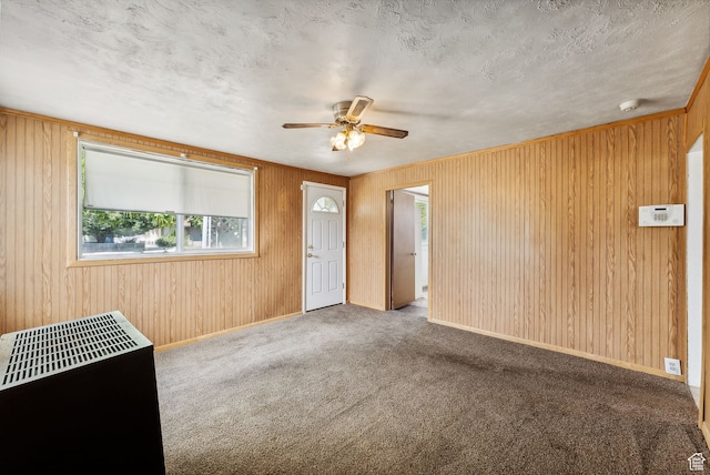 7865 S Main St, Midvale, UT 84047 - carpeted empty room featuring ceiling fan, a textured ceiling, and wooden walls