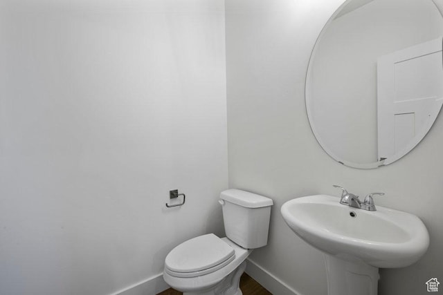 3475 S Perthshire Dr Unit 30, South Salt Lake, UT 84115 - bathroom with toilet, baseboards, and a sink