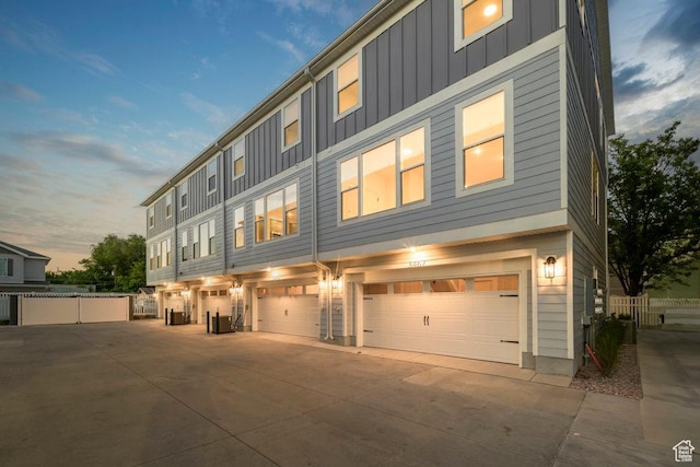 3475 S Perthshire Dr Unit 30, South Salt Lake, UT 84115 - view of property with board and batten siding, concrete driveway, and a garage