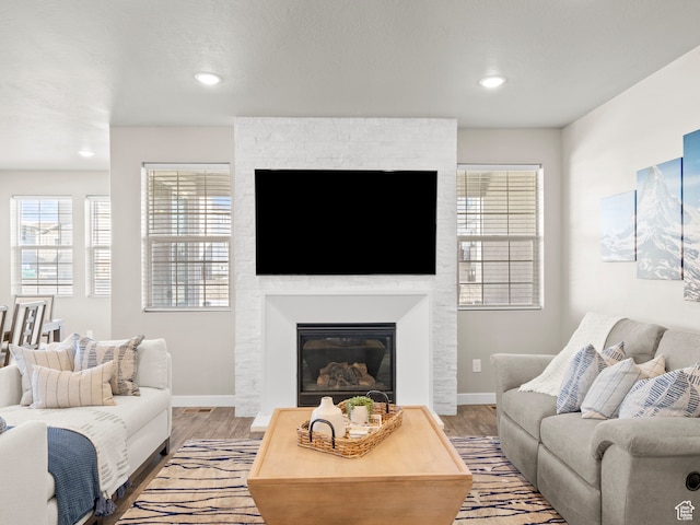 2424 N Lazy J Ln, Lehi, UT 84043 - living room with hardwood / wood-style floors, a large fireplace, and a textured ceiling