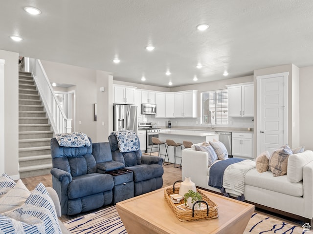 2424 N Lazy J Ln, Lehi, UT 84043 - living room with sink, a textured ceiling, and light wood-type flooring