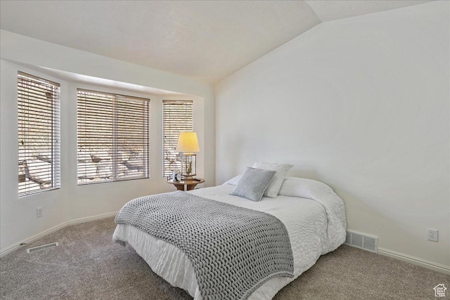 bedroom featuring visible vents, baseboards, carpet, and vaulted ceiling