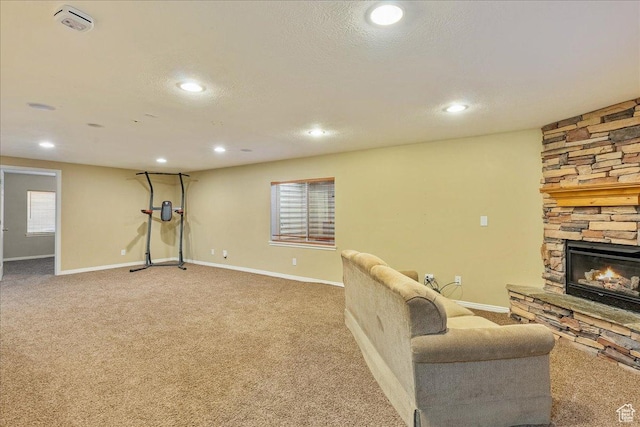 living area featuring recessed lighting, a fireplace, baseboards, and carpet floors