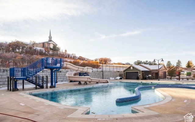 2159 E Bald Eagle Ct S, Draper, UT 84020 - community pool with a water slide, stairway, fence, and a patio area