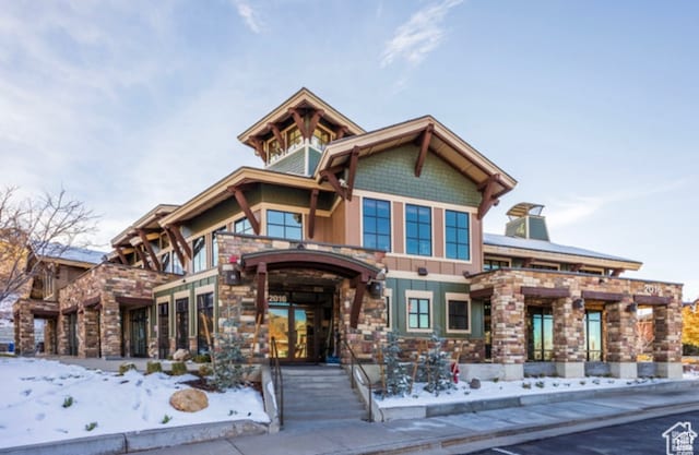 craftsman-style house featuring stone siding